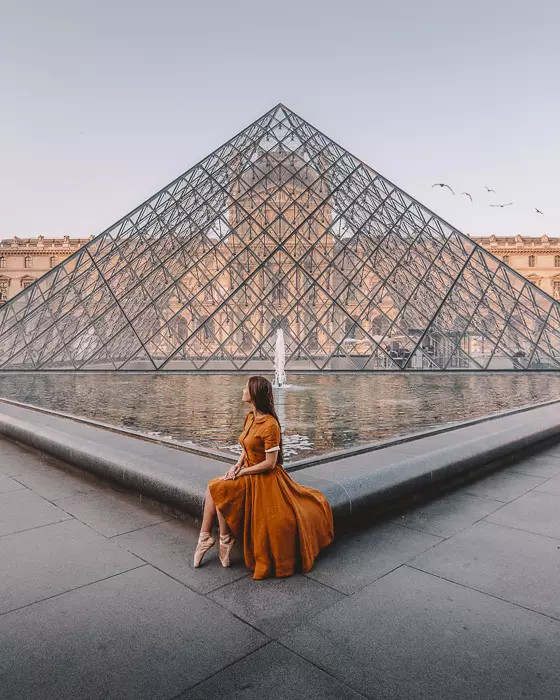 Sitting on the side of the Louvre pyramid by Dancing the Earth