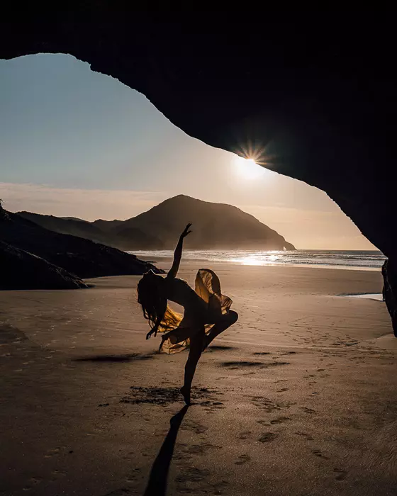 Dancing inside a cave in Wharariki Beach, South Island, Dancing the Earth