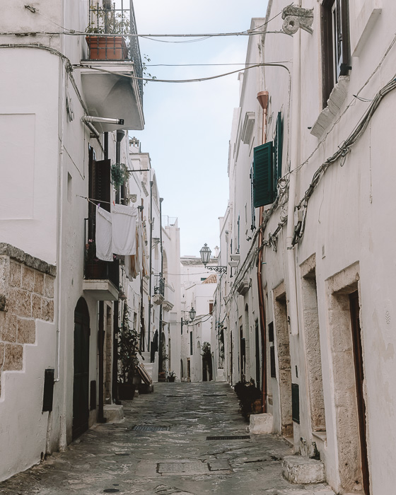 Coblestone white street in Ostuni, Puglia travel guide by Dancing the Earth